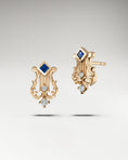 Load image into Gallery viewer, Lyre shapped earrings made in gold with diamonds and blue sapphire
